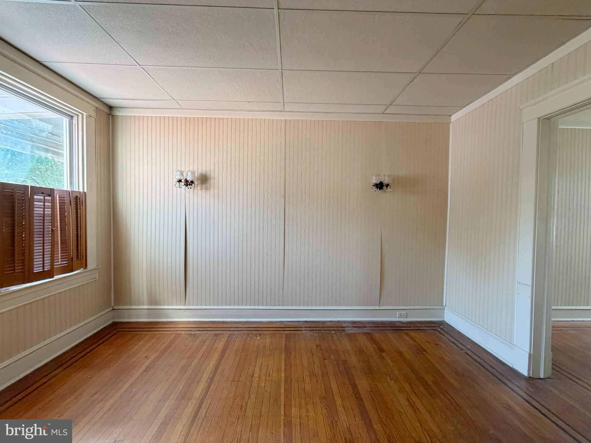 2802 Brighton Street Baltimore, MD 21216 - Photo 6 of 38 a view of an empty room with wooden floor and a window