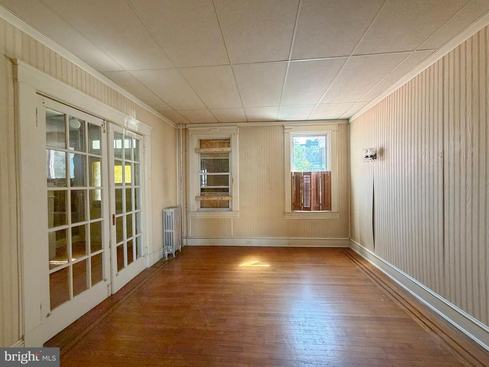 2802 Brighton Street Baltimore, MD 21216 - Photo 7 of 38 a view of empty room with wooden floor and fan