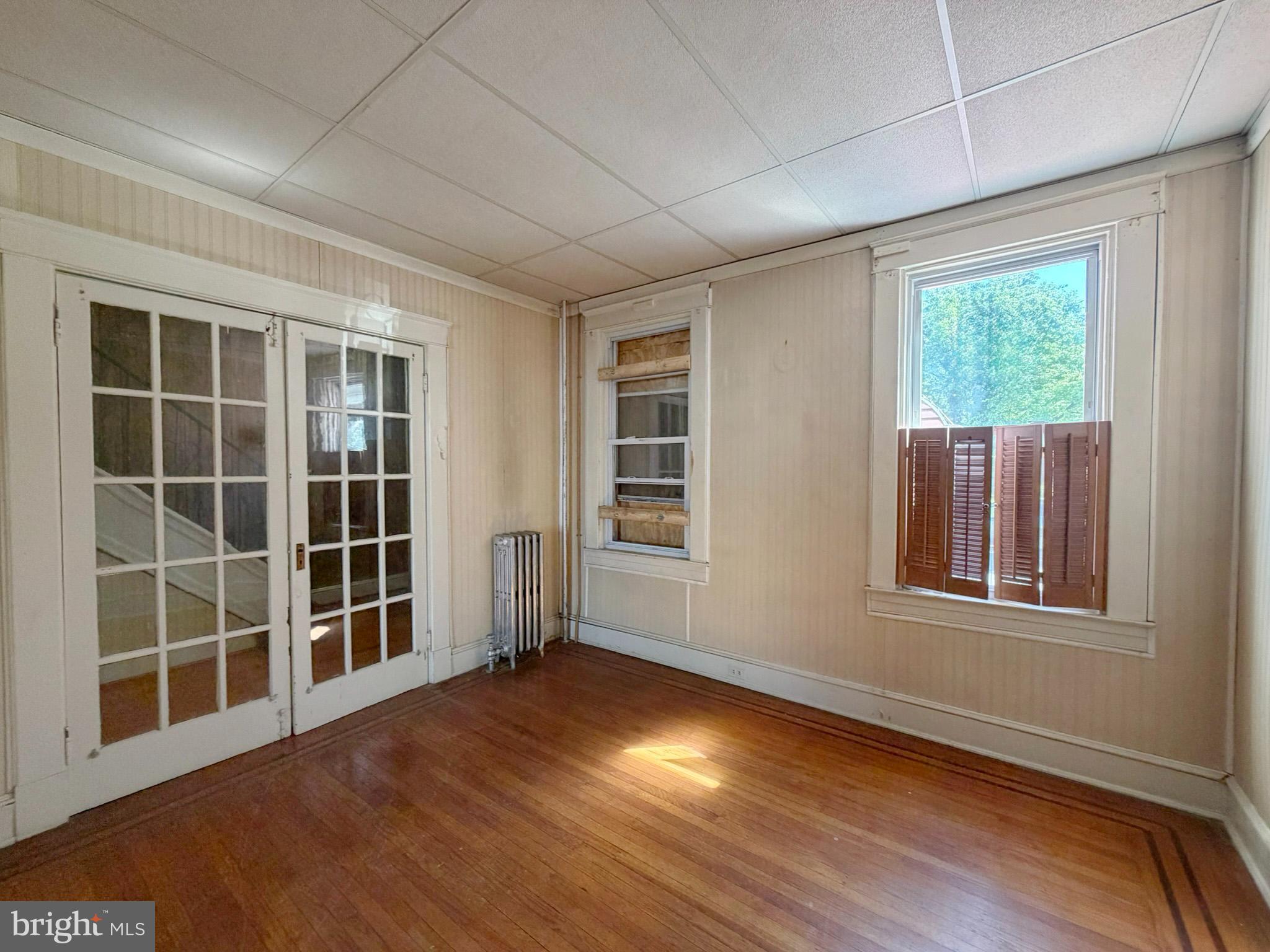 2802 Brighton Street Baltimore, MD 21216 - Photo 8 of 38 an empty room with wooden floor and windows