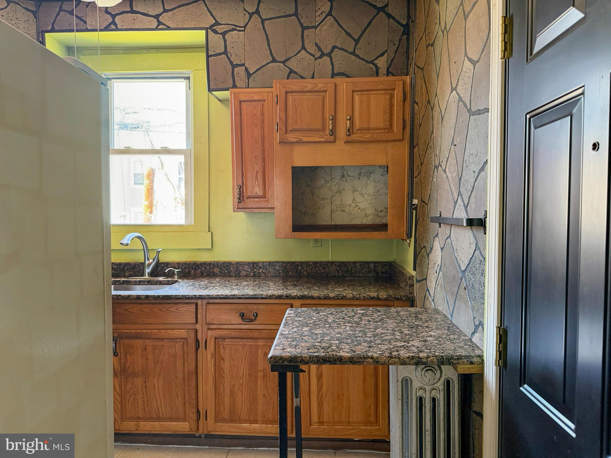 2802 Brighton Street Baltimore, MD 21216 - Photo 10 of 38 a kitchen with granite countertop cabinets and window