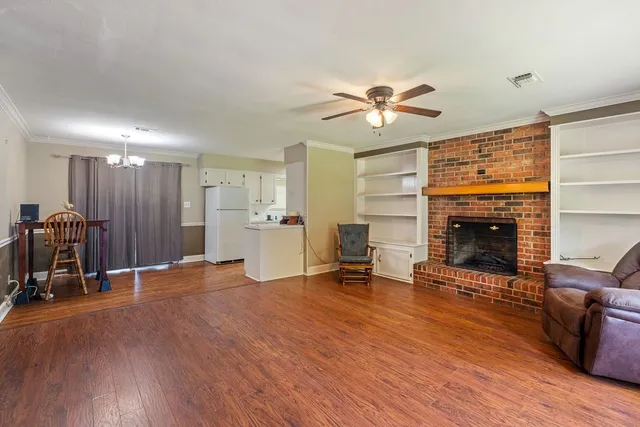 a view of kitchen with refrigerator microwave and wooden floor