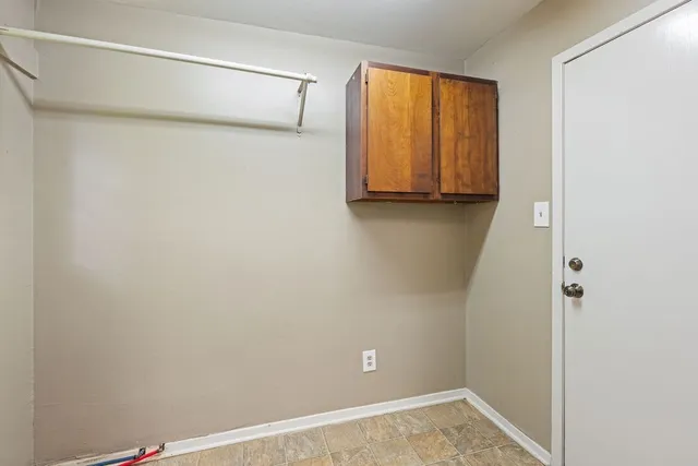 a view of a room with furniture and windows