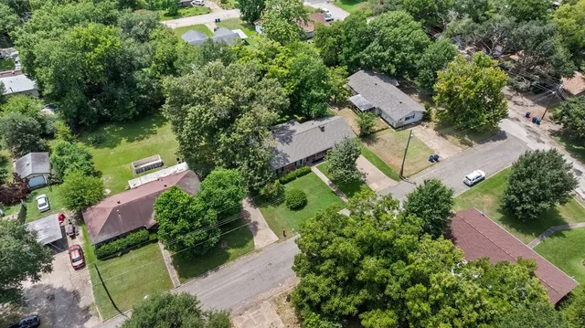 an aerial view of a house with outdoor space and street view