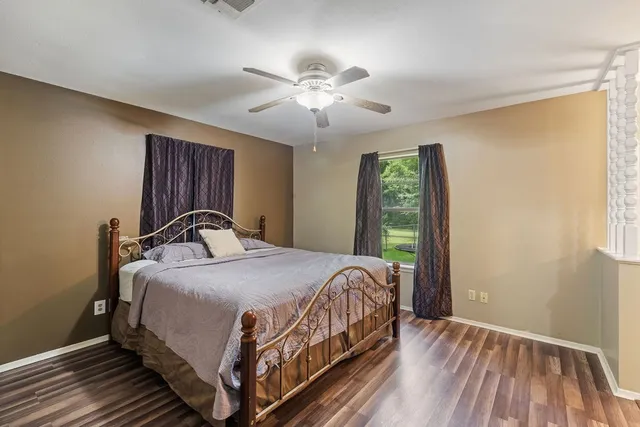 a bedroom with a bed and window