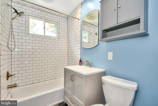 a bathroom with a toilet a sink and bathtub