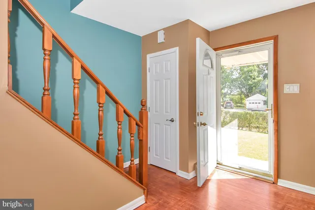 a view of an entryway with wooden floor