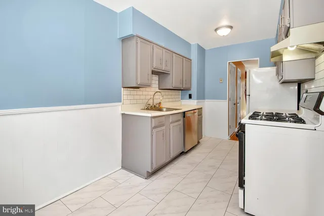 a kitchen with a sink cabinets and stainless steel appliances
