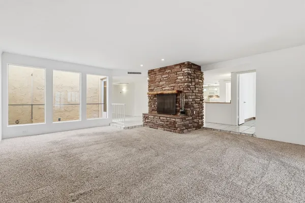 an empty room with furniture and a fireplace