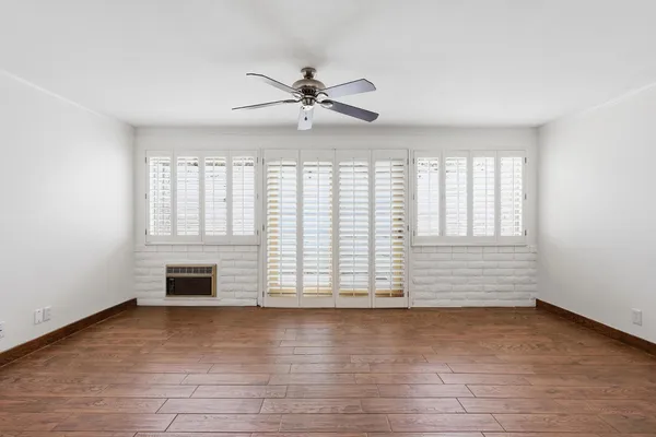wooden floor in an empty room with a window