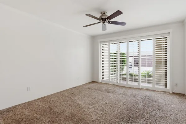 a view of a livingroom with a ceiling fan and window