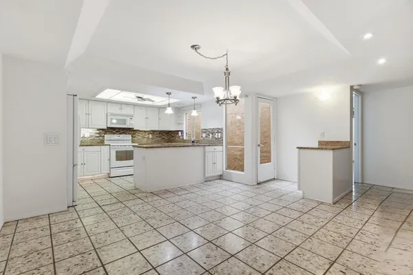 a large kitchen with cabinets and stainless steel appliances