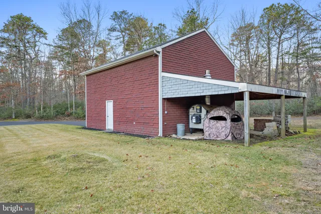 a view of a bench in the garden near a lake