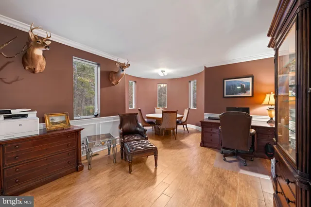 a view of a hallway with wooden floor and entryway