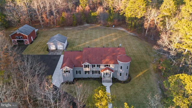 an aerial view of a house with swimming pool yard and outdoor seating