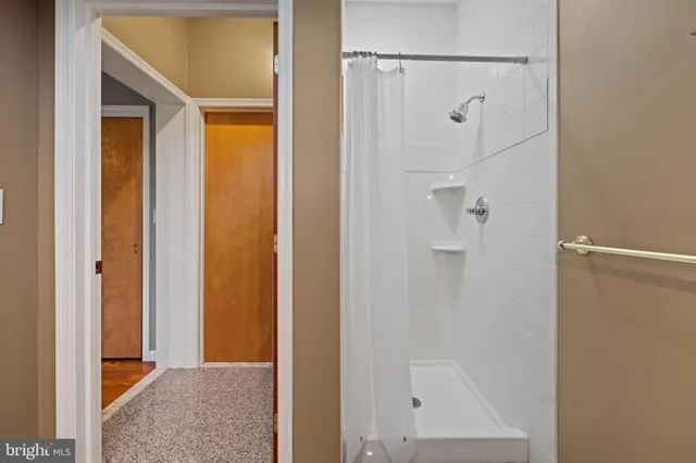 a view of an empty room with window and cabinet