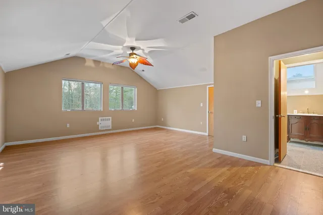 a living room with furniture a bookshelf and a large window