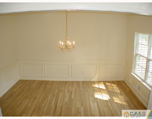 84 Harding Avenue Edison, NJ 08820 - Photo 4 of 8 a view of a room with wooden floor and chandelier