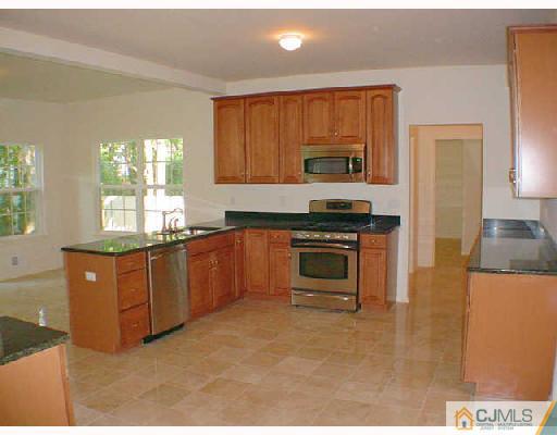 84 Harding Avenue Edison, NJ 08820 - Photo 5 of 8 a kitchen with stainless steel appliances granite countertop a stove a sink and a refrigerator