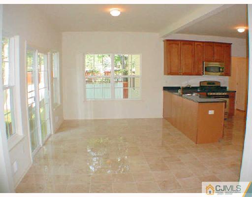 84 Harding Avenue Edison, NJ 08820 - Photo 6 of 8 a kitchen with granite countertop a stove a sink and a refrigerator