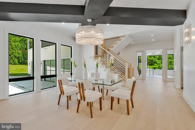a large kitchen with kitchen island a sink a center island a stove and a view of living room