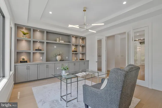 a kitchen with stainless steel appliances granite countertop a sink a stove and white cabinets with wooden floor