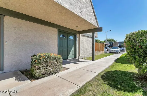 a backyard of a house with yard and outdoor seating