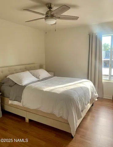 a large bed sitting in a bedroom next to a window