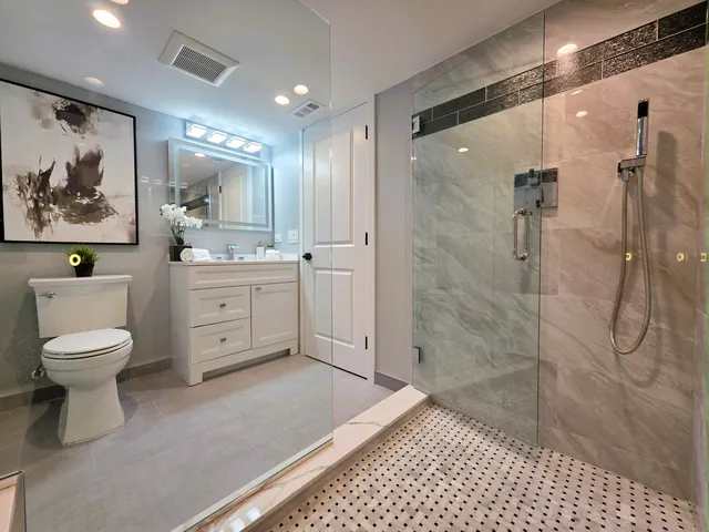 a view of a big room with wooden floor and a bathroom