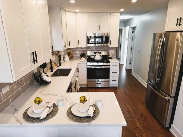 a kitchen with stainless steel appliances a refrigerator sink and microwave