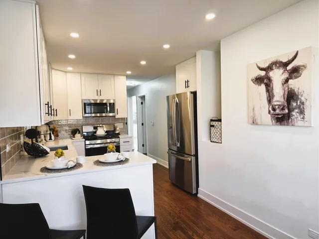 a view of a dining room with furniture and wooden floor