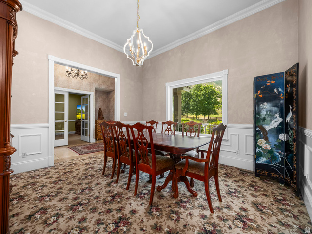 1317 South Pond Circle Mapleton, UT 84664 - Photo 5 of 63 Dining area featuring a decorative chandelier, crown molding, and wainscoting