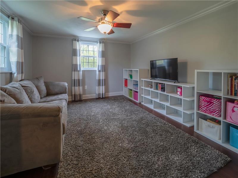 4137 Ewalt Road Gibsonia, PA 15044 - Photo 4 of 25 Spacious den is graces with modern paint and new bamboo HW flooring. This room is versatile and just off entryway and can be used for anything you imagine.