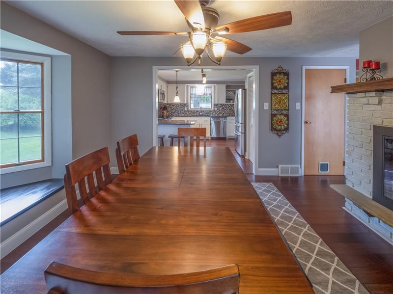 4137 Ewalt Road Gibsonia, PA 15044 - Photo 10 of 25 Gorgeous dining room open to kitchen. Bay window adds charm and space with views of the trees. Double sided wood burning fireplace creates a unique and classic dining experience.