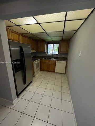 a kitchen with stainless steel appliances cabinets a sink and a counter top