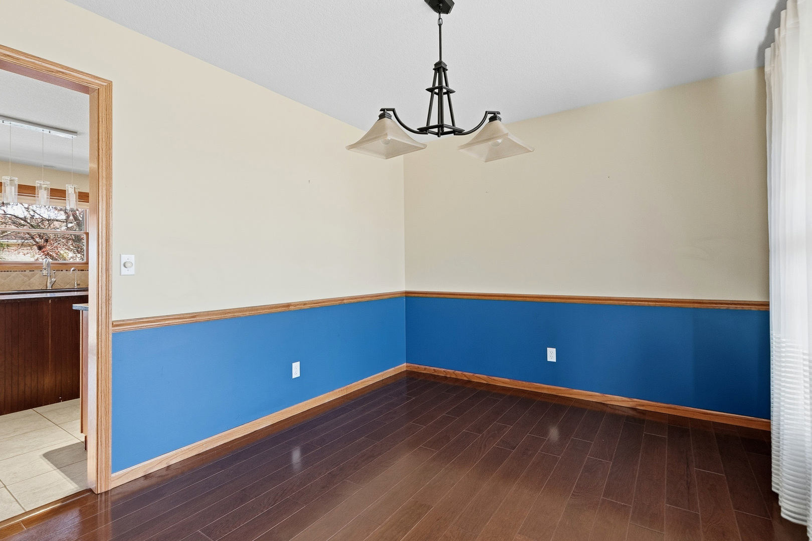 2052 Ashford Road Bettendorf, IA 52722 - Photo 11 of 40 a view of an empty room with wooden floor and a window