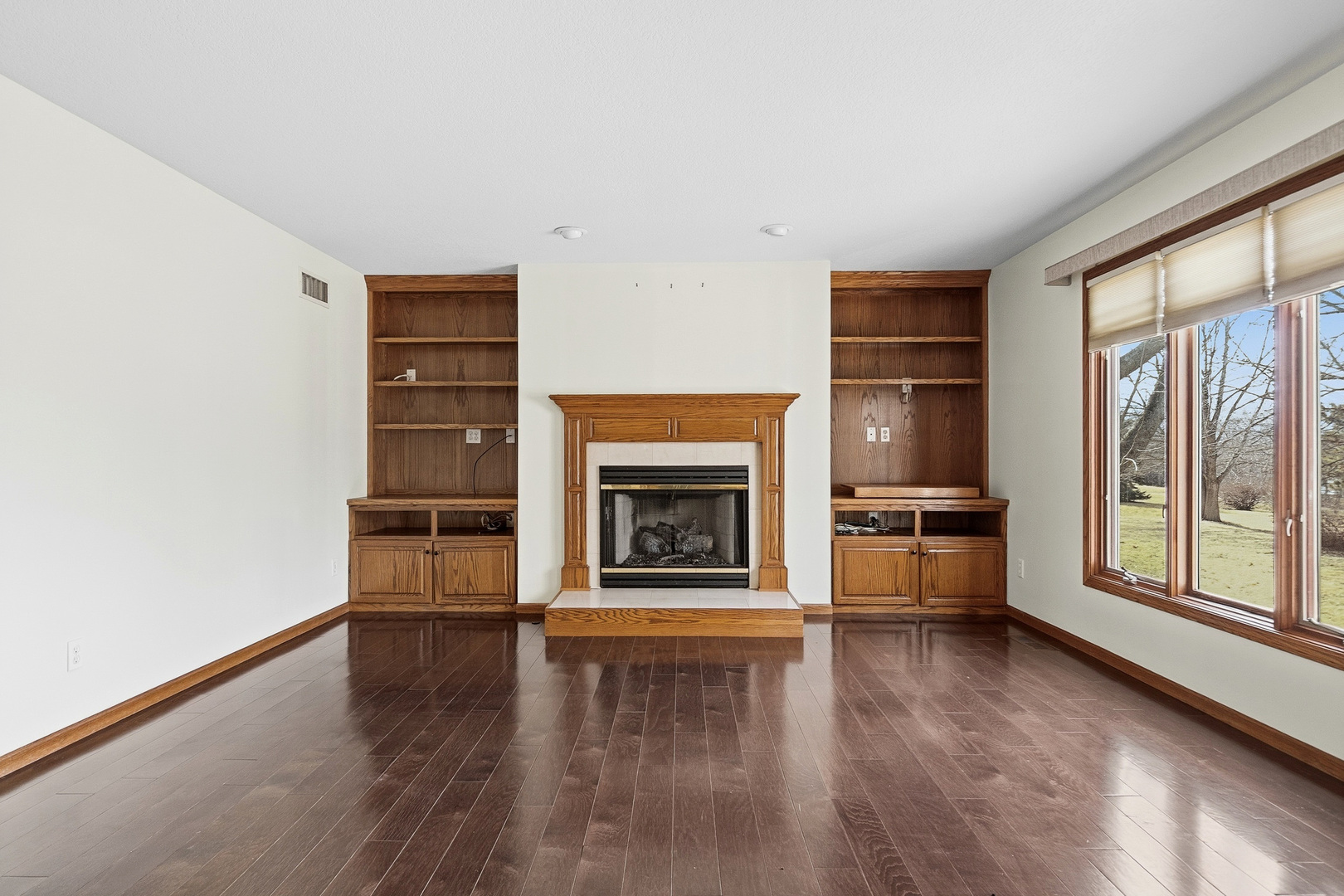 2052 Ashford Road Bettendorf, IA 52722 - Photo 15 of 40 a living room with a fireplace and a floor to ceiling window