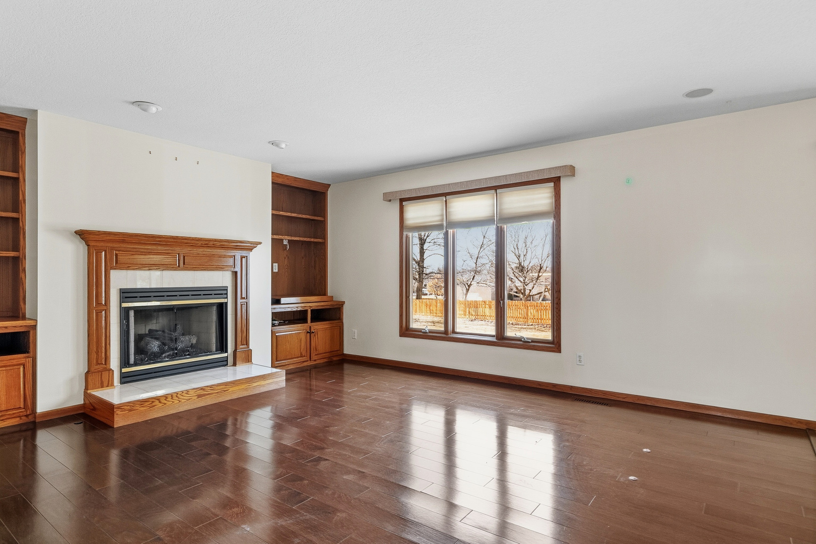 2052 Ashford Road Bettendorf, IA 52722 - Photo 16 of 40 a view of an empty room with a fireplace and a window