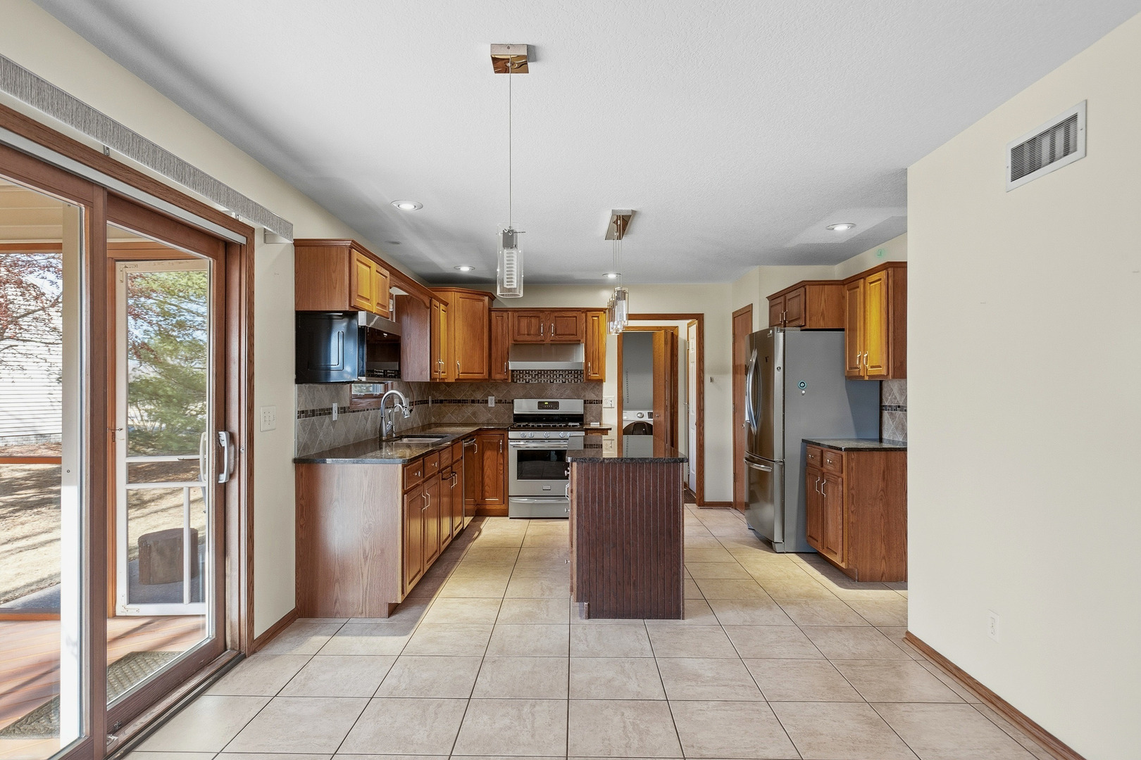 2052 Ashford Road Bettendorf, IA 52722 - Photo 18 of 40 a kitchen with stainless steel appliances granite countertop a refrigerator and a sink
