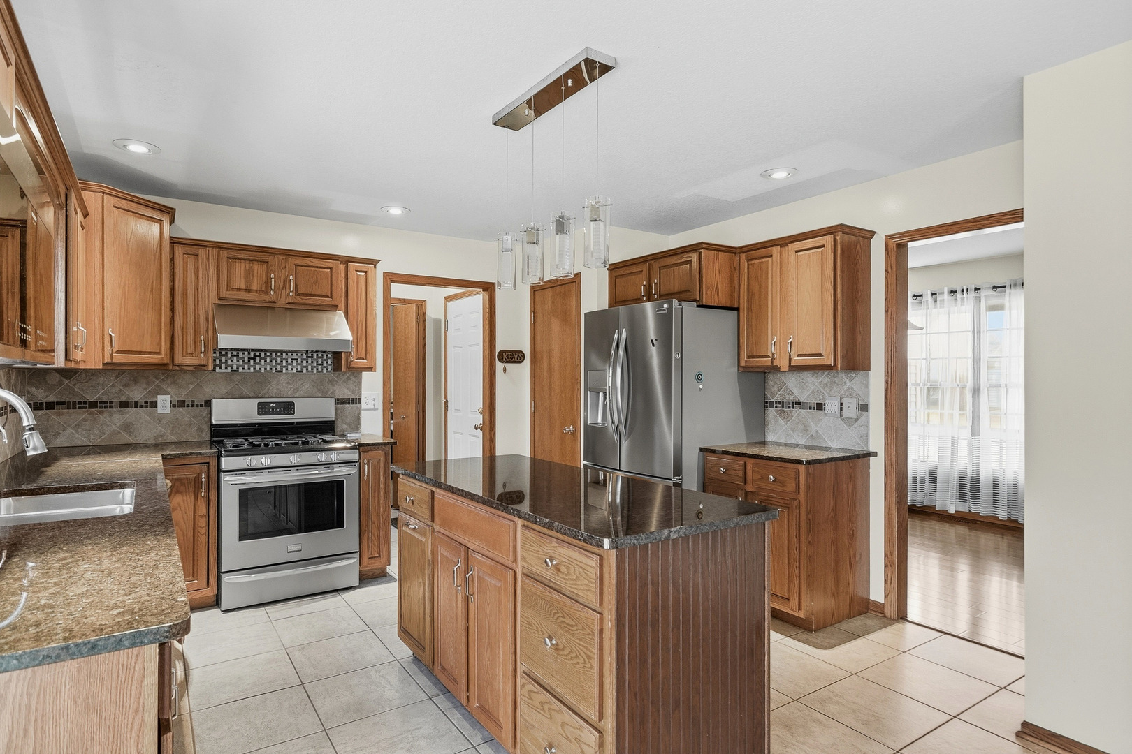 2052 Ashford Road Bettendorf, IA 52722 - Photo 19 of 40 a kitchen with stainless steel appliances granite countertop a refrigerator and a stove top oven