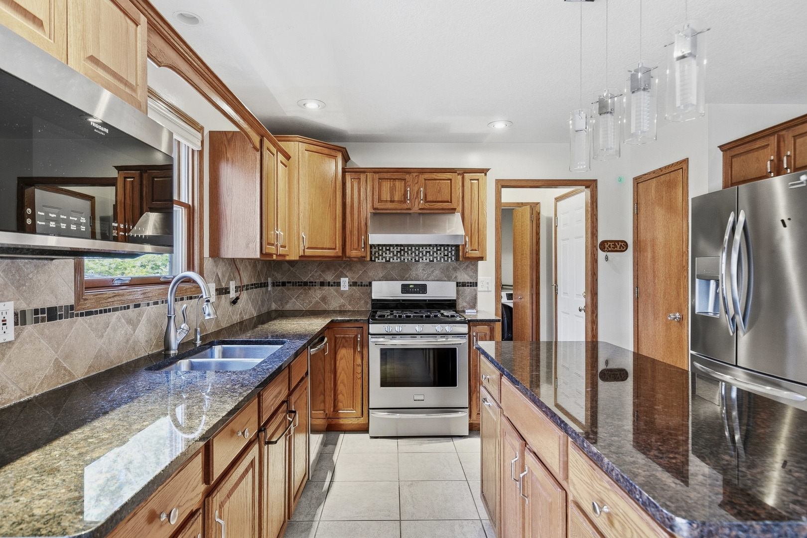 2052 Ashford Road Bettendorf, IA 52722 - Photo 22 of 40 a kitchen with stainless steel appliances granite countertop a refrigerator a stove and a sink