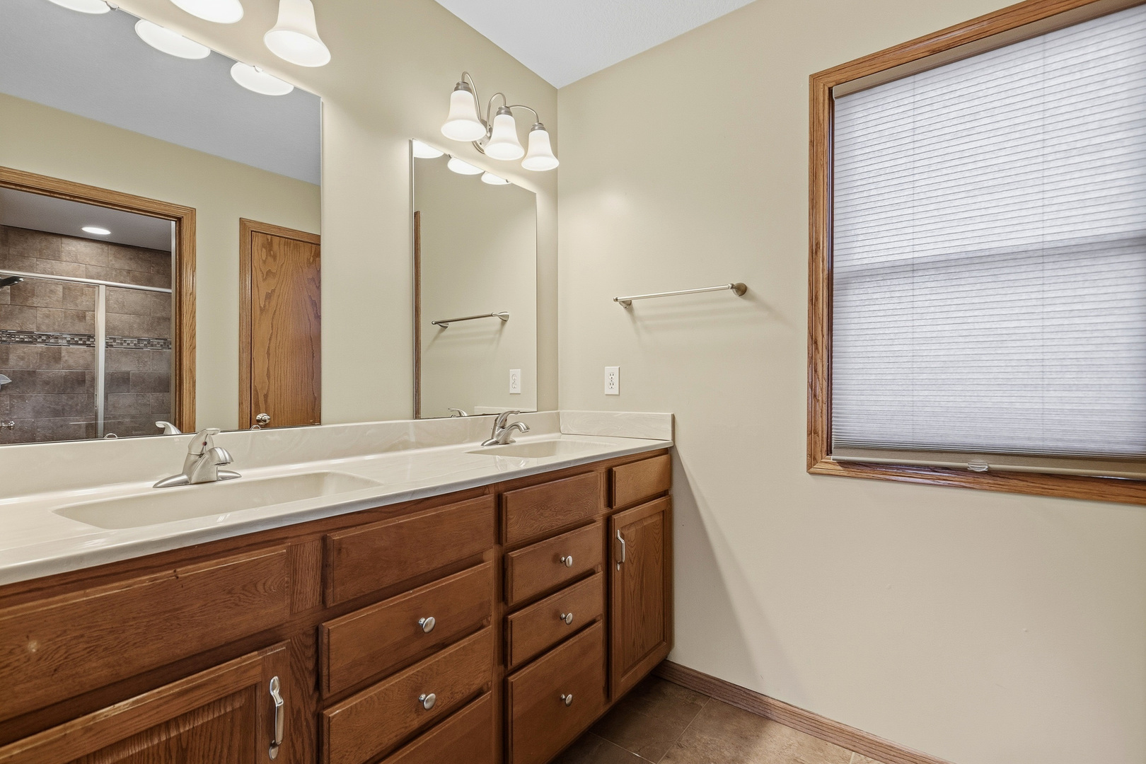 2052 Ashford Road Bettendorf, IA 52722 - Photo 28 of 40 a bathroom with a double vanity sink and a mirror