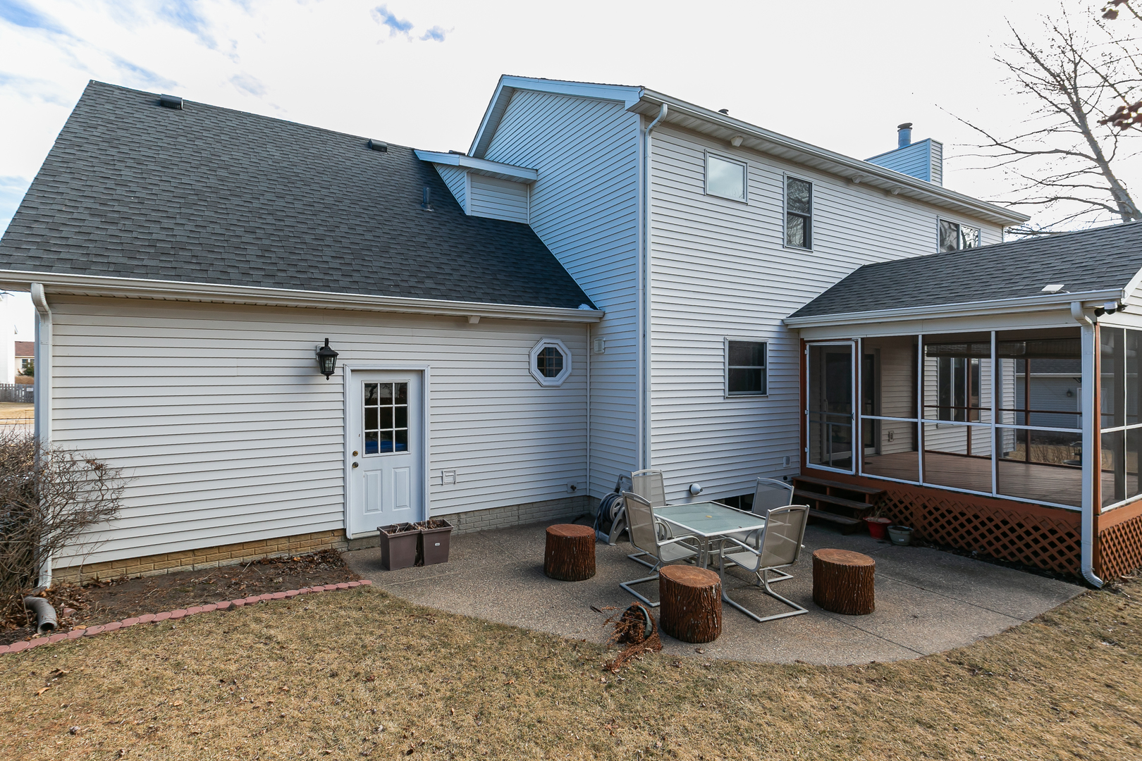 2052 Ashford Road Bettendorf, IA 52722 - Photo 6 of 40 a backyard of a house with blue plants and couch