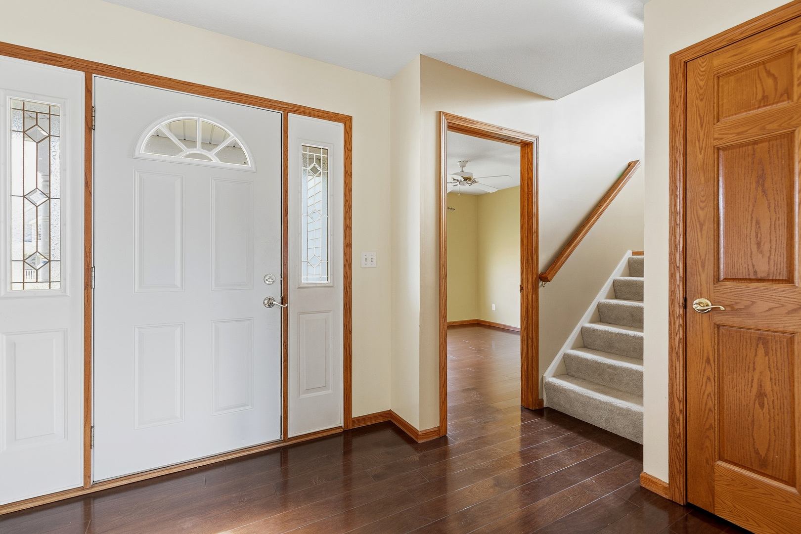 2052 Ashford Road Bettendorf, IA 52722 - Photo 8 of 40 a view of a hallway with stairs and wooden floor