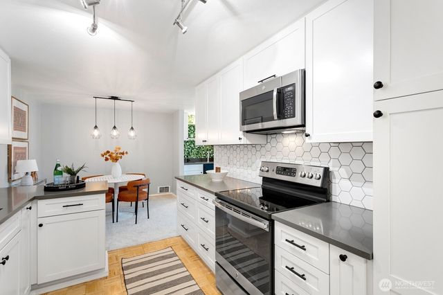 a living room with furniture a fireplace and a potted plant
