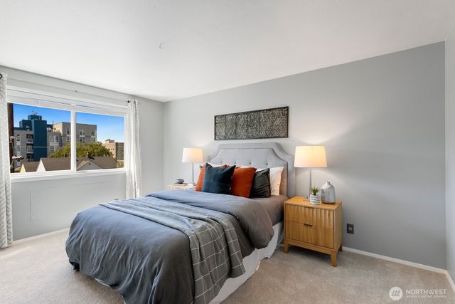 a bedroom with a bed and a lamp