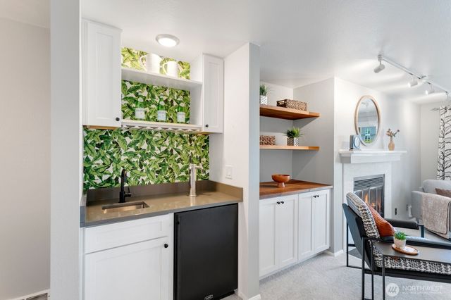a dining room filled chandelier and wooden furniture