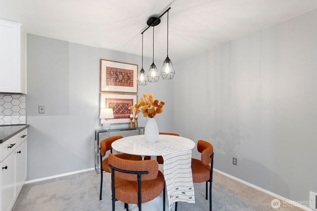 a kitchen with stainless steel appliances a stove a sink dishwasher a refrigerator white cabinets and wooden floor