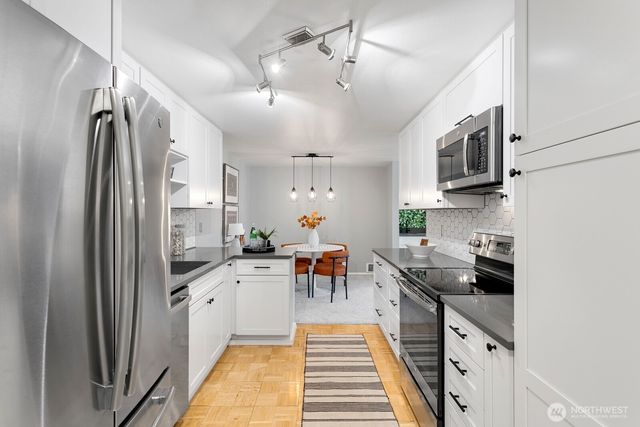 a kitchen with a sink and refrigerator