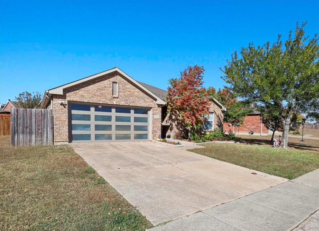 1412 Cheyenne Road Wylie, TX 75098 - Photo 2 of 24 View of front facade featuring concrete driveway, an attached garage, and brick siding