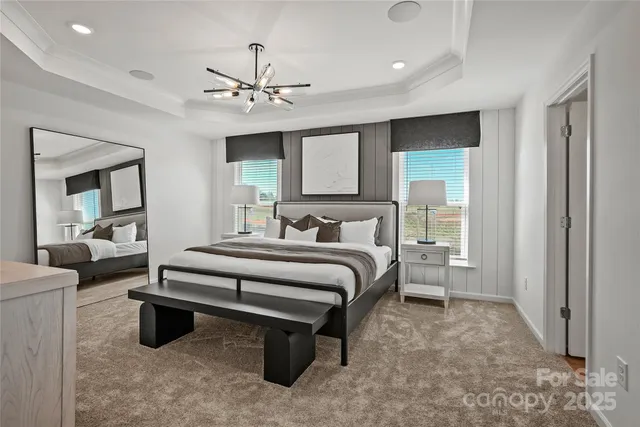 a spacious bedroom with a bed and a chandelier